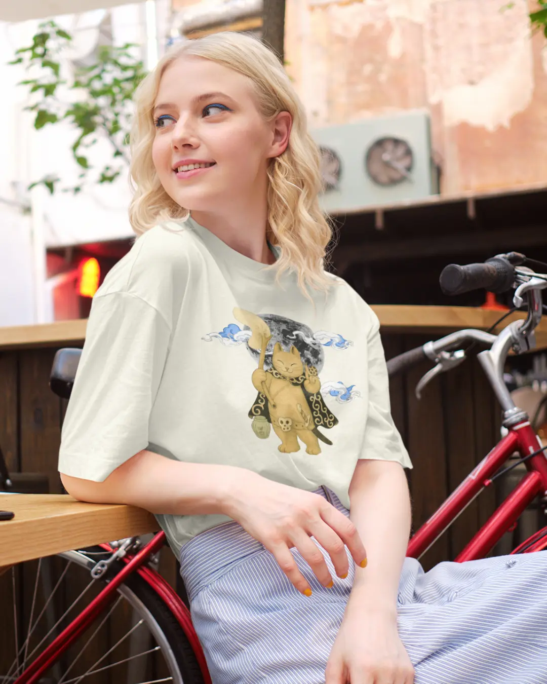 Oversized streetwear t-shirt featuring samurai cat standing beneath a full moon, minimalist Japanese-inspired design.